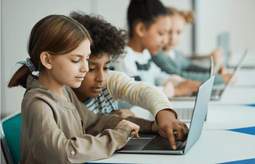 Children using a laptop during an electronic recycling awareness session