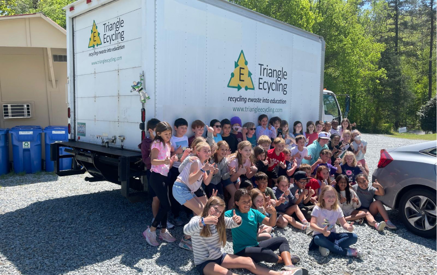 Children learning about electronic recycling at an educational workshop